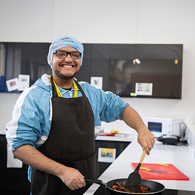 Students cooking in the living kitchen